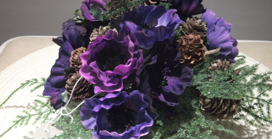 Z101 Christmas arrangement with purple anemones, ferns and pinecones